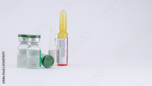 Medicines concept showing Coronavirus Vaccine ampoules with vials against white background.