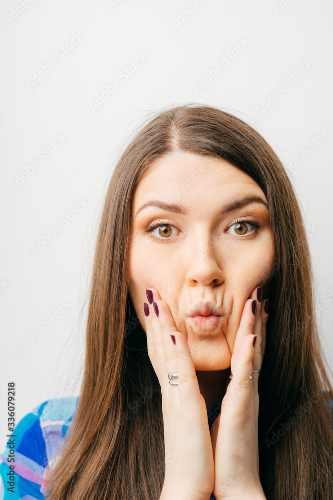 young, upset, worried, troubled brunette woman holding her head with hand young, upset, worried, troubled brunette woman holding her head with hand