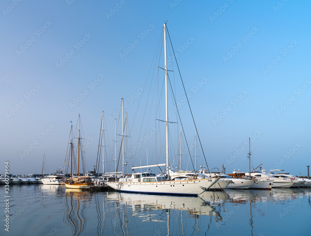 yacht in marine with reflections in water in the morning in Greece