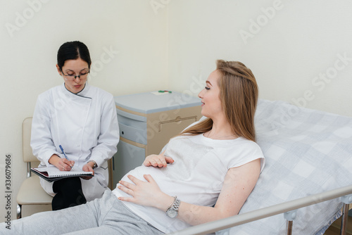 The doctor advises and serves a young pregnant girl in a medical clinic. Medical examination