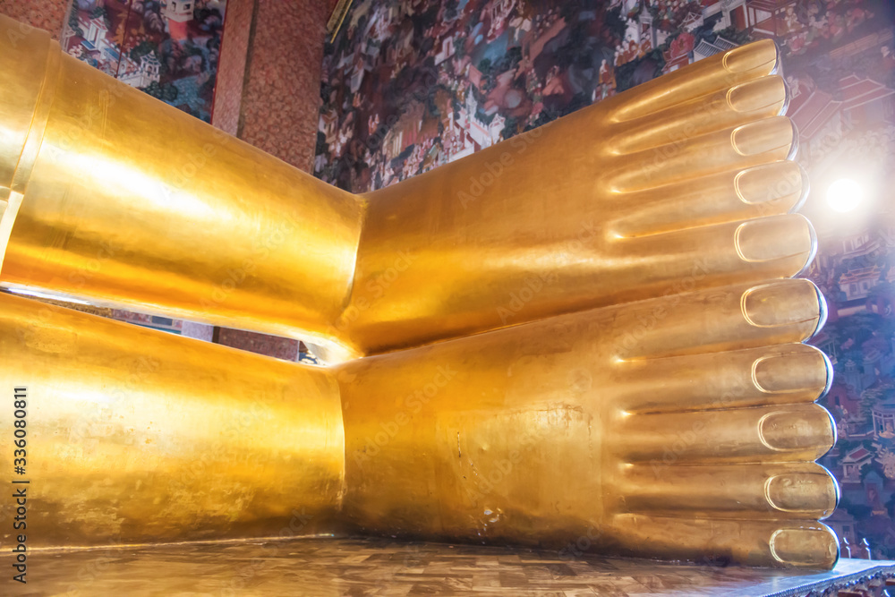 Feet of big golden statue of Reclining Buddha in temple Wat Pho. Bangkok, Thailand