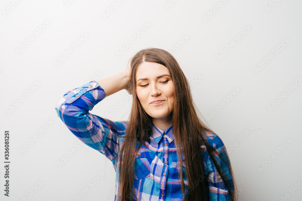 Pretty woman with hand on head gesturing migraine headache in white background Pretty woman with hand on head gesturing migraine headache in white background