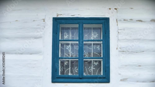 Blue window on wooden white house