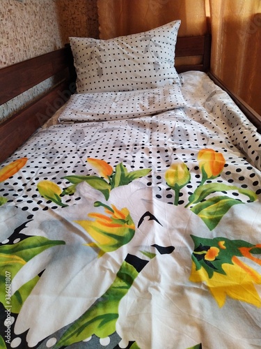 Obraz na plátne Made-up wooden baby bed with pillows in bedroom