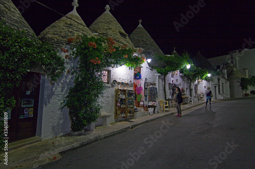 Night view of the streets with the characteristic trulli of the town of Alberobello in Puglia, Italy.