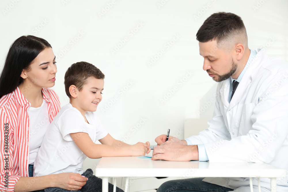 Little boy with mother visiting orthopedist at clinic Little boy with mother visiting orthopedist at clinic