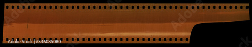 real scan of undeveloped cine 35mm filmstrip with cool scanning light interferences on the material, film type 135 isolated on black background. 