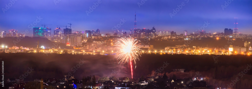Panorama of holiday fireworks in a city with blue night sky