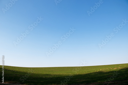 landscape with blue sky and green grass