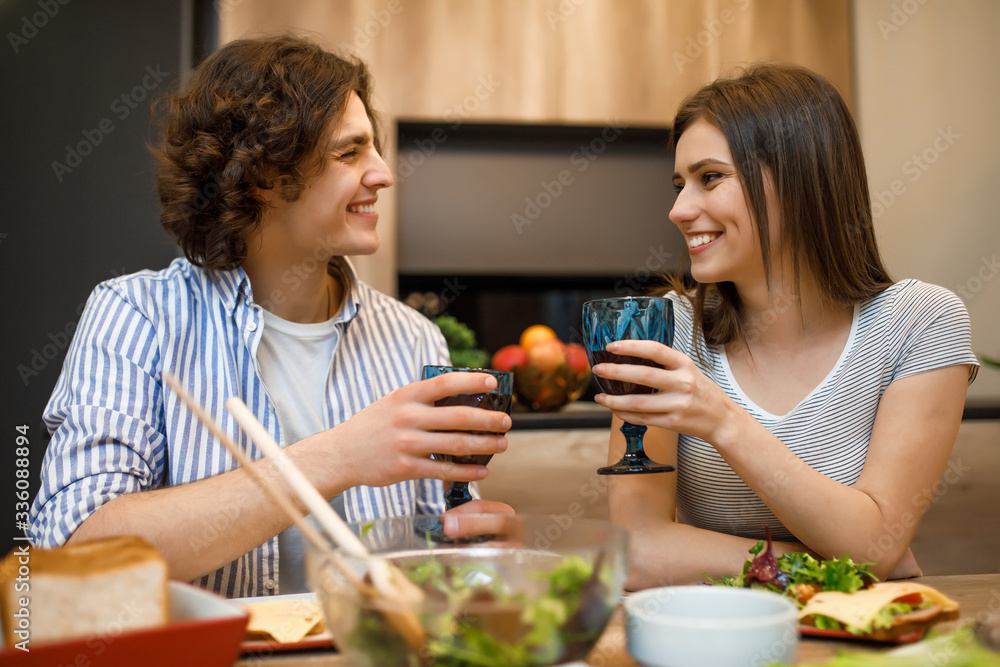Romantic evening, couplespend time at home kitchen with wine glasses Romantic evening, couplespend time at home kitchen with wine glasses