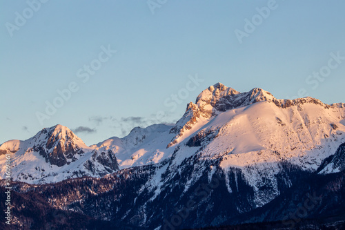 Sunlit Triglav peak from Bohinj valley, early light