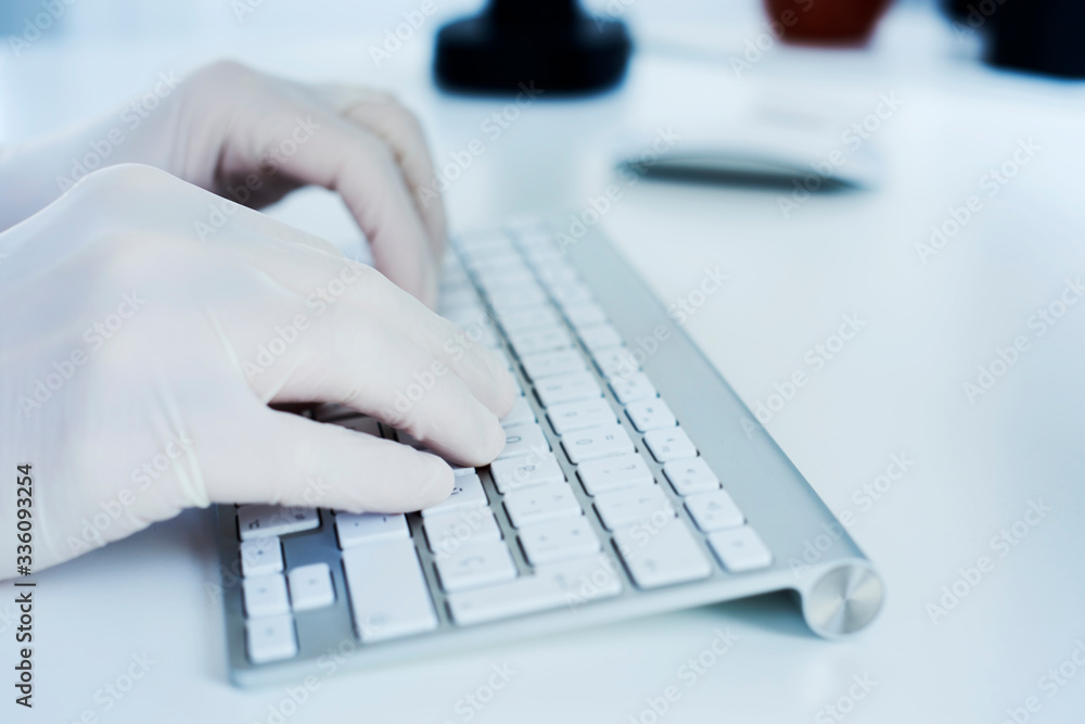 man using a computer wearing latex gloves man using a computer wearing latex gloves