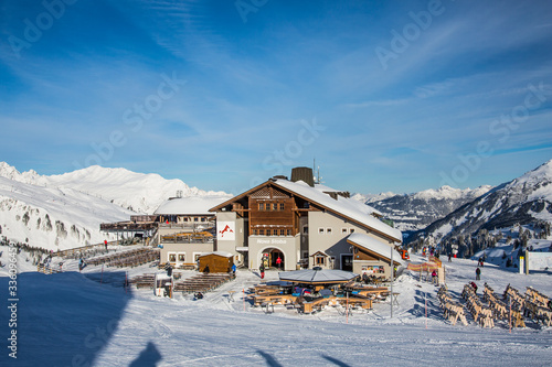 Gaschurn, Vorarlberg, Austria, January 2020, Restaurant Nova Stoba, eating house with the snow covered mountain range - panoramic view 