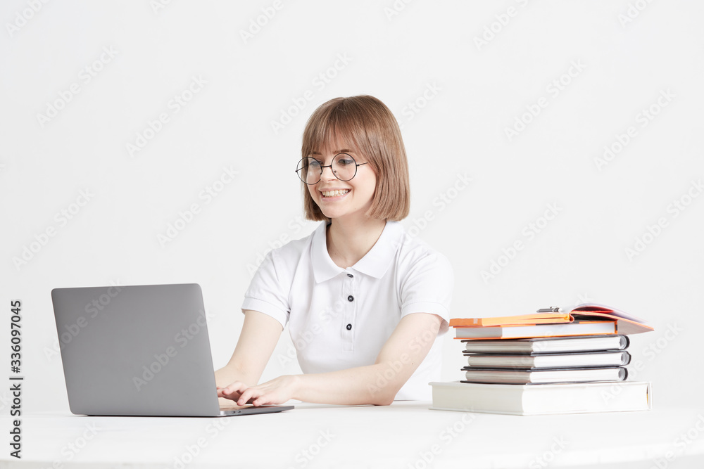 Cool happy girl goes through online training sitting at home. Remote school education on a laptop. Stay home lessons. Cool happy girl goes through online training sitting at home. Remote school education on a laptop. Stay home lessons.