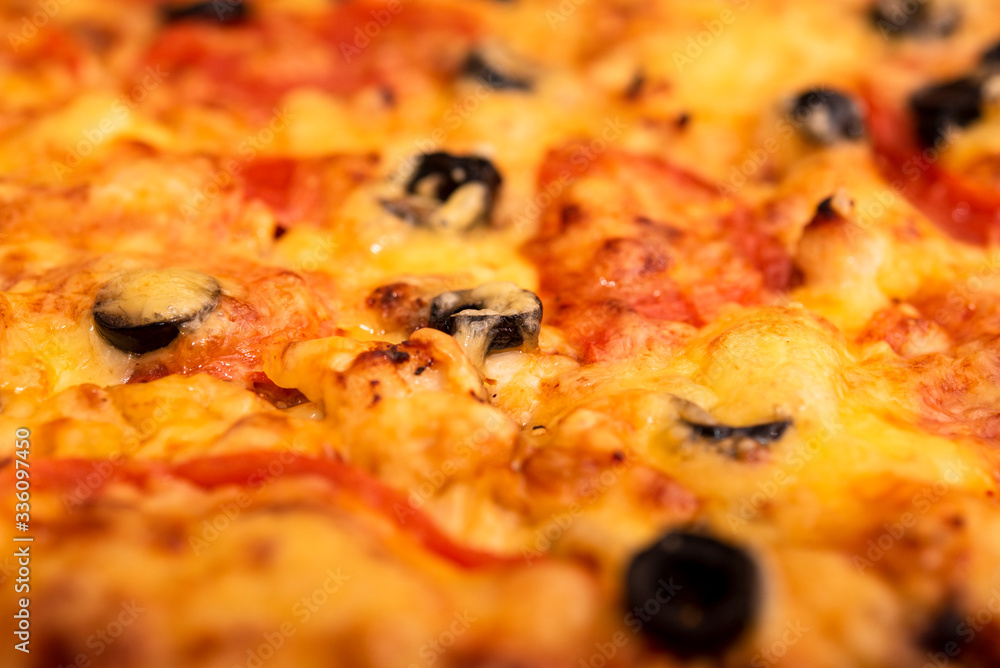 baked pizza background with cheese, tomatoes and olives baked pizza background with cheese, tomatoes and olives