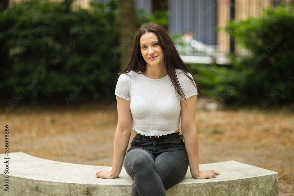 portrait of a cute brunette sitting in the park portrait of a cute brunette sitting in the park