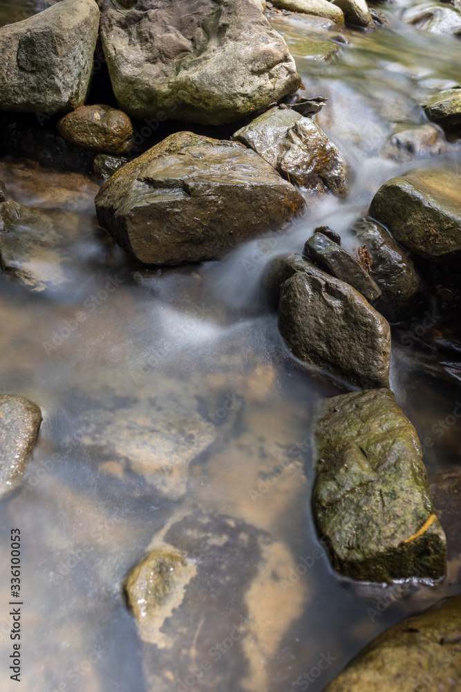 Photo of nature - Long exposure of a mountain stony creek inside in the forest. Small mountain rocky river. Photo of nature - Long exposure of a mountain stony creek inside in the forest. Small mountain rocky river.