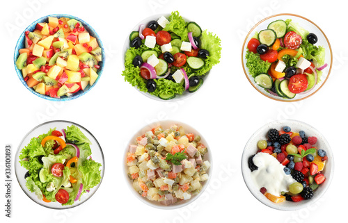Set with different salads on white background, top view