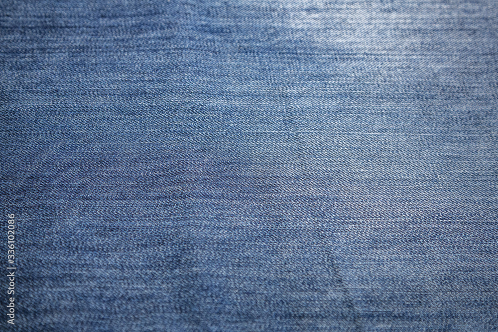 Blue textured surface of a thick cotton denim fabric Blue textured surface of a thick cotton denim fabric