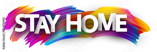 Big stay home sign over brush strokes background.
