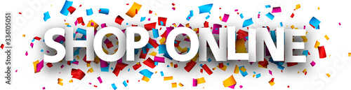 Big white shop online sign on confetti background.