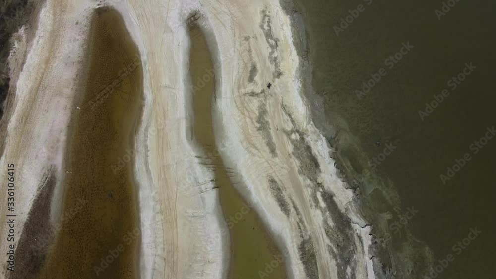 Aerial view, flying over the salty sands of the litoral zone on Kuyalnik Liman. Camera moving forwards along the coastline Kuyalnik Estuary, Odessa Oblast, Ukraine Aerial view, flying over the salty sands of the litoral zone on Kuyalnik Liman. Camera moving forwards along the coastline Kuyalnik Estuary, Odessa Oblast, Ukraine