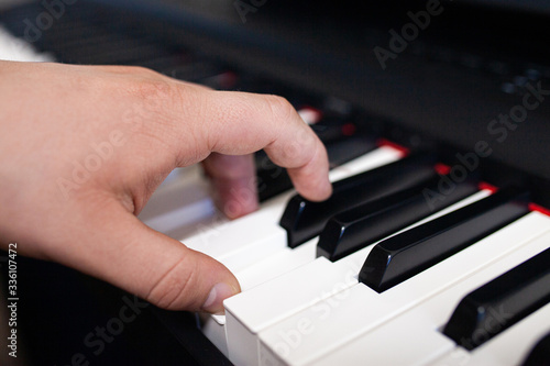 Close up of man's hands playing on keyboard