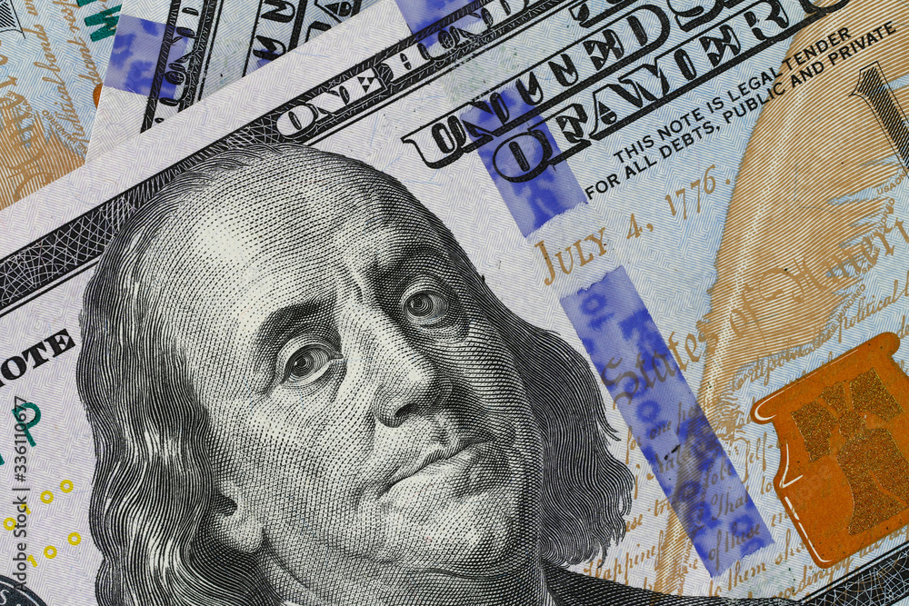 Naklejka premium Background of money. Macro shot of a new 100 dollar bill. Close-up, horizontal, cropped shot. Concept of financial crisis.