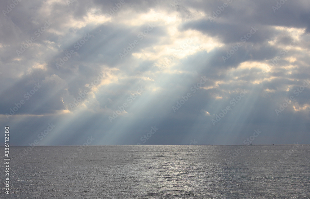 sunbeams through the clouds over the sea