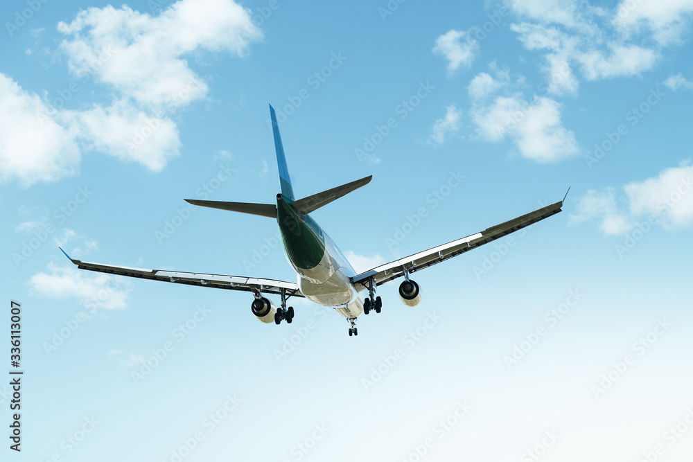 commercial airplane flying seen from behind