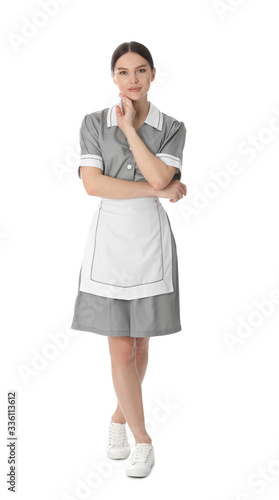 Young chambermaid in uniform on white background