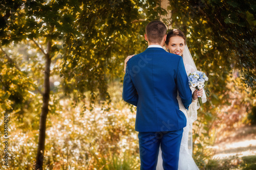 Happy couple on wedding day. Walk the bride and groom in the national park in autumn. Beautiful wedding. © Maxim