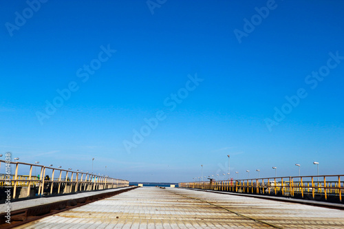 Old rusty railway bridge to the sea on the shipyard