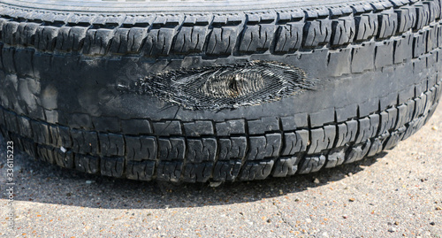 rubbed wheel of lorry. worn wheel with hole in tire, worn rubber tread to cord