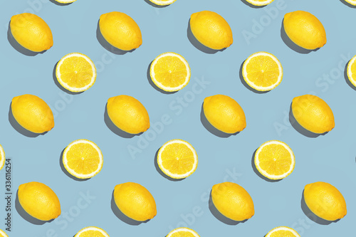 Colorful fruit pattern of fresh lemon slices on colored background. Lemon slices top view. With sharpen shadows © Aliaksei