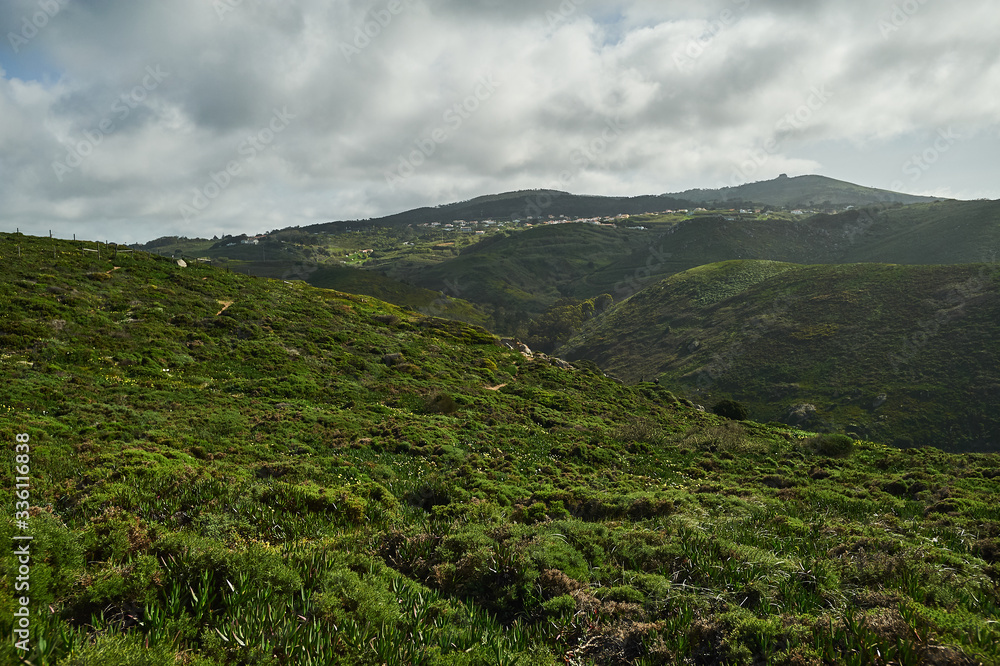 Green cliff and blue sky