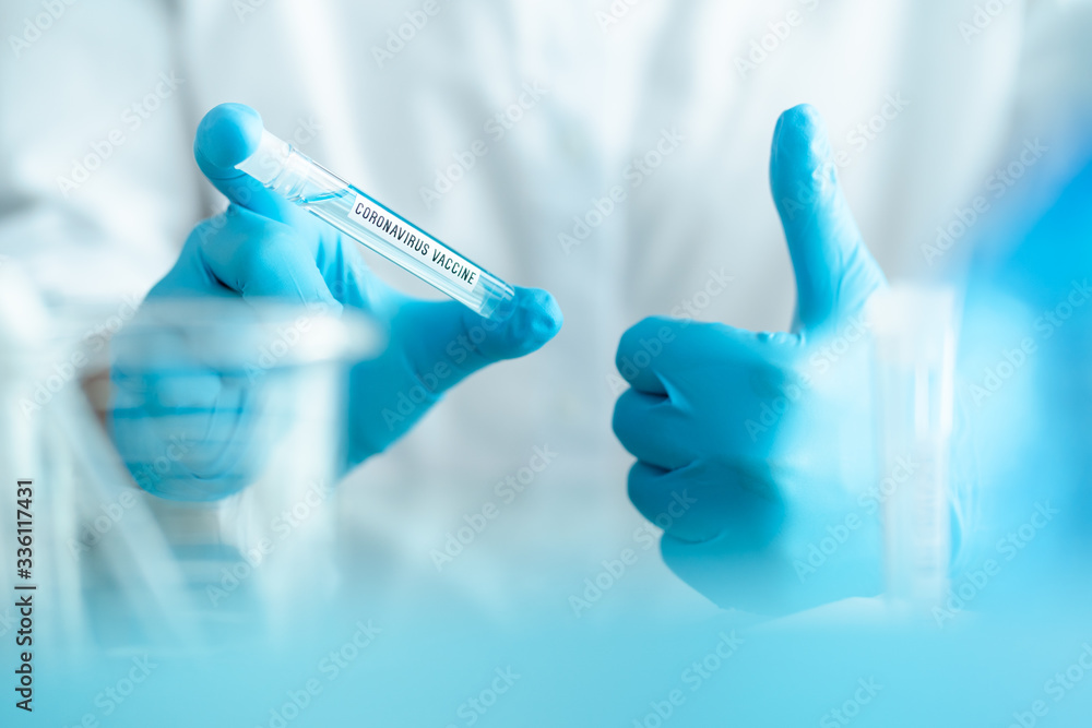 scientist holding test tube with covid-19 or coronavirus vaccine label with blurred hand gesture, lab testing for inventing pandemic medication scientist holding test tube with covid-19 or coronavirus vaccine label with blurred hand gesture, lab testing for inventing pandemic medication