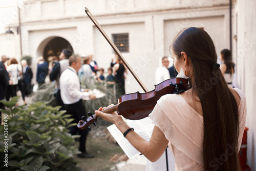 violinist playing violin music during wedding elegance  photo