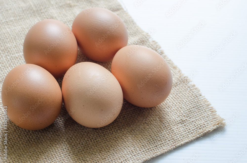 .Raw chicken eggs, high protein, organic, healthy with sackcloth on the floor .Raw chicken eggs, high protein, organic, healthy with sackcloth on the floor