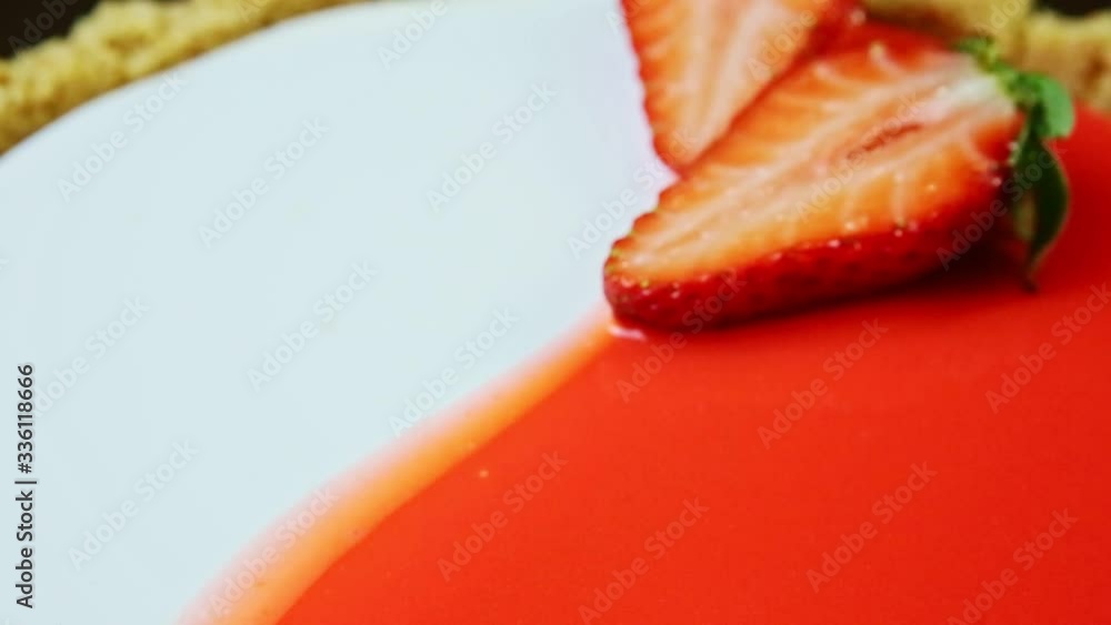 closeup panorama down on glazed cheesecake surface with sliced strawberries closeup panorama down on glazed cheesecake surface with sliced strawberries