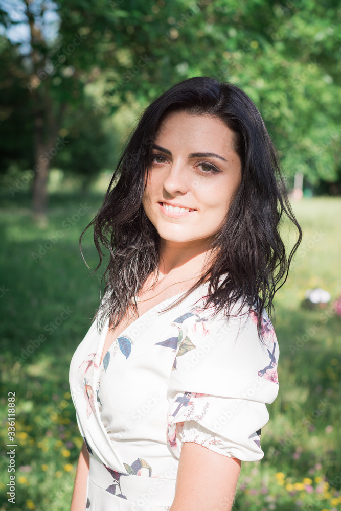 Outdoor Portrait young curly hair woman arms crossed smiling Outdoor Portrait young curly hair woman arms crossed smiling