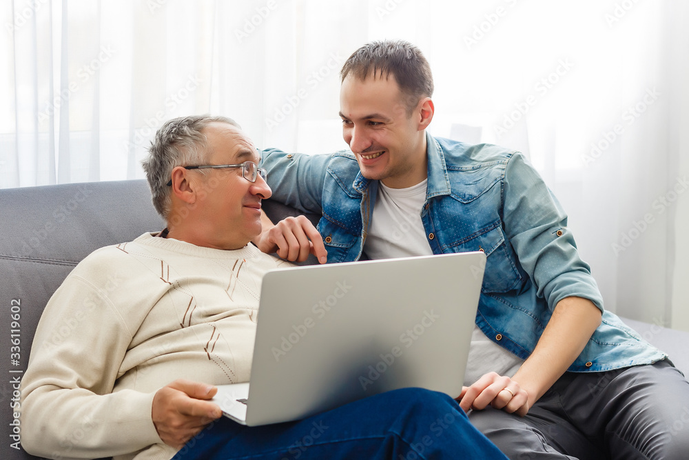 Self-isolation because of coronavirus outbreak. Father is remote working with his son on self quarantine. Lockdown. Self-isolation because of coronavirus outbreak. Father is remote working with his son on self quarantine. Lockdown.