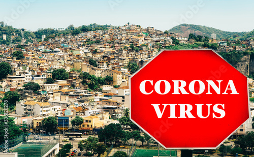 Rio de Janeiro, Brazil hillside shantytown also known as a favela with a Corona virus Covid-19 warning sign