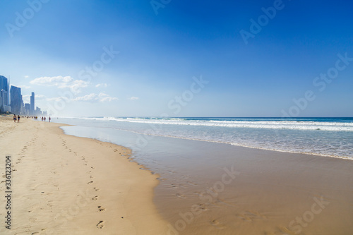 Footprints in the sand leading to Surfers Paradise highrises