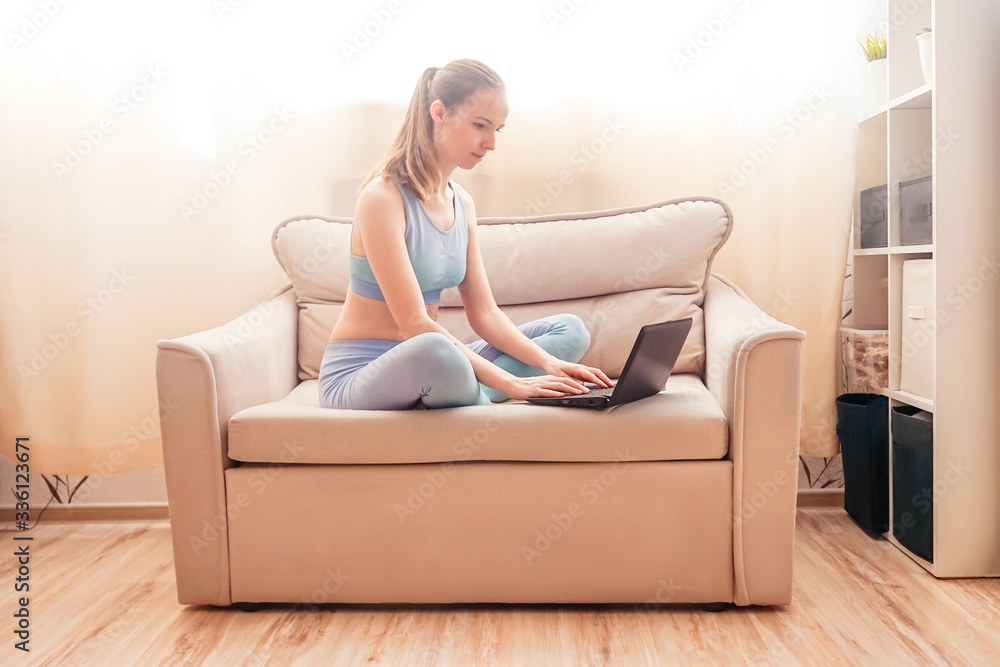 Woman using a laptop on the couch. Woman using a laptop on the couch.