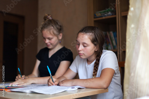  High school students doing homework at home.