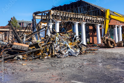 A one story building with white columns destroyed by fire full of debris