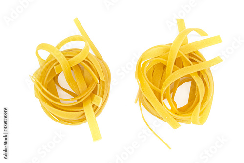 Fettuccine, rolled Italian pasta isolated on white background