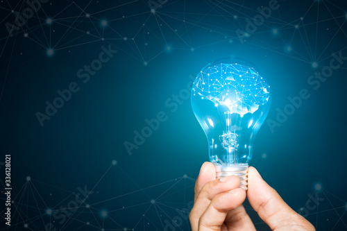 light bulb hold in hand on blue background, Brain with shining wireframe, Neural networks and artificial intelligence
