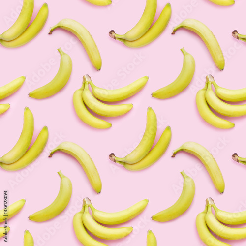 Bananas on a pink background, top view. Seamless pattern, food background.